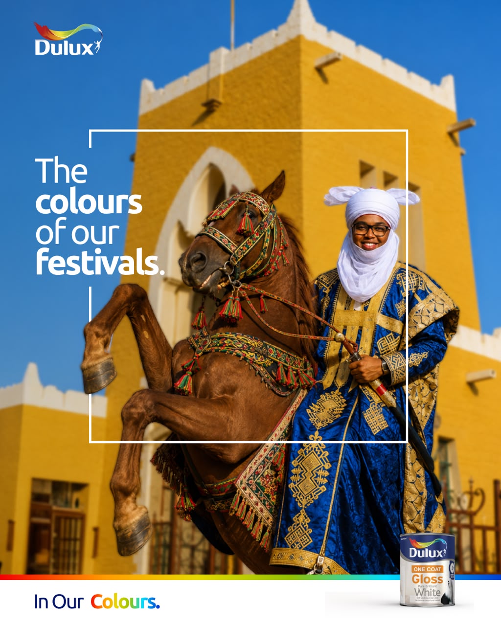 Dulux key visual, a durbar rider in blue and gold before a yellow palace wall