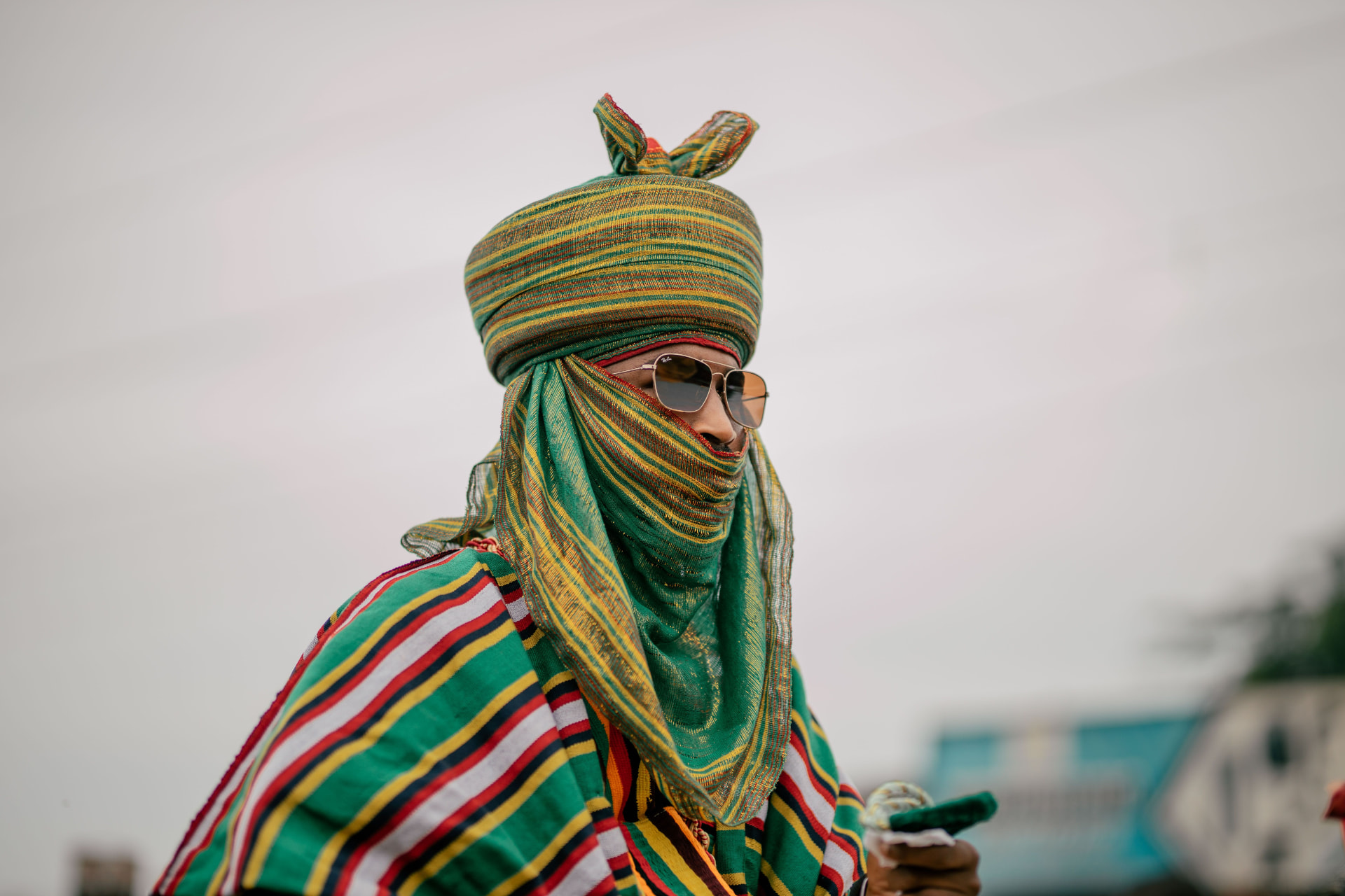 A durbar rider in a striped green and gold turban and robe