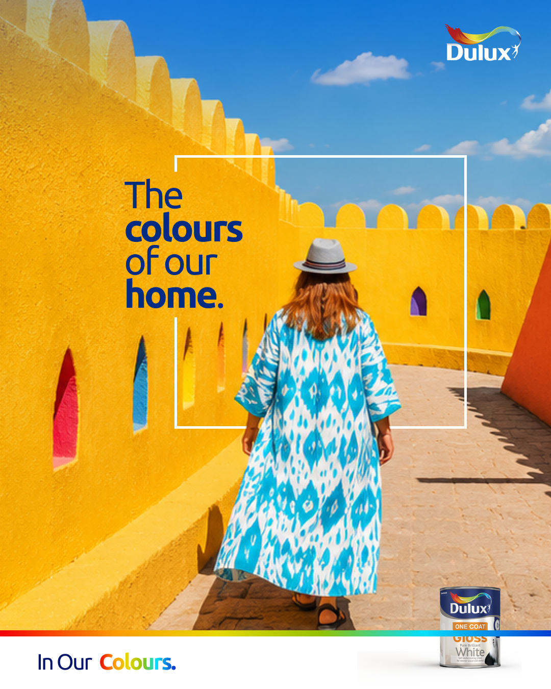 Dulux key visual, a woman in a blue and white patterned dress walking through sunlit yellow walls