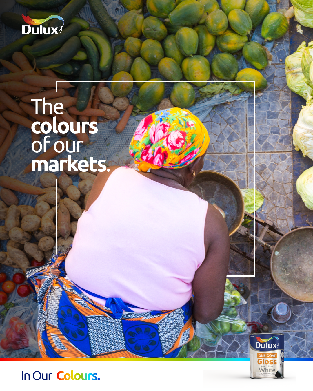 Dulux key visual, a market vendor in a bright floral headwrap surrounded by fresh produce
